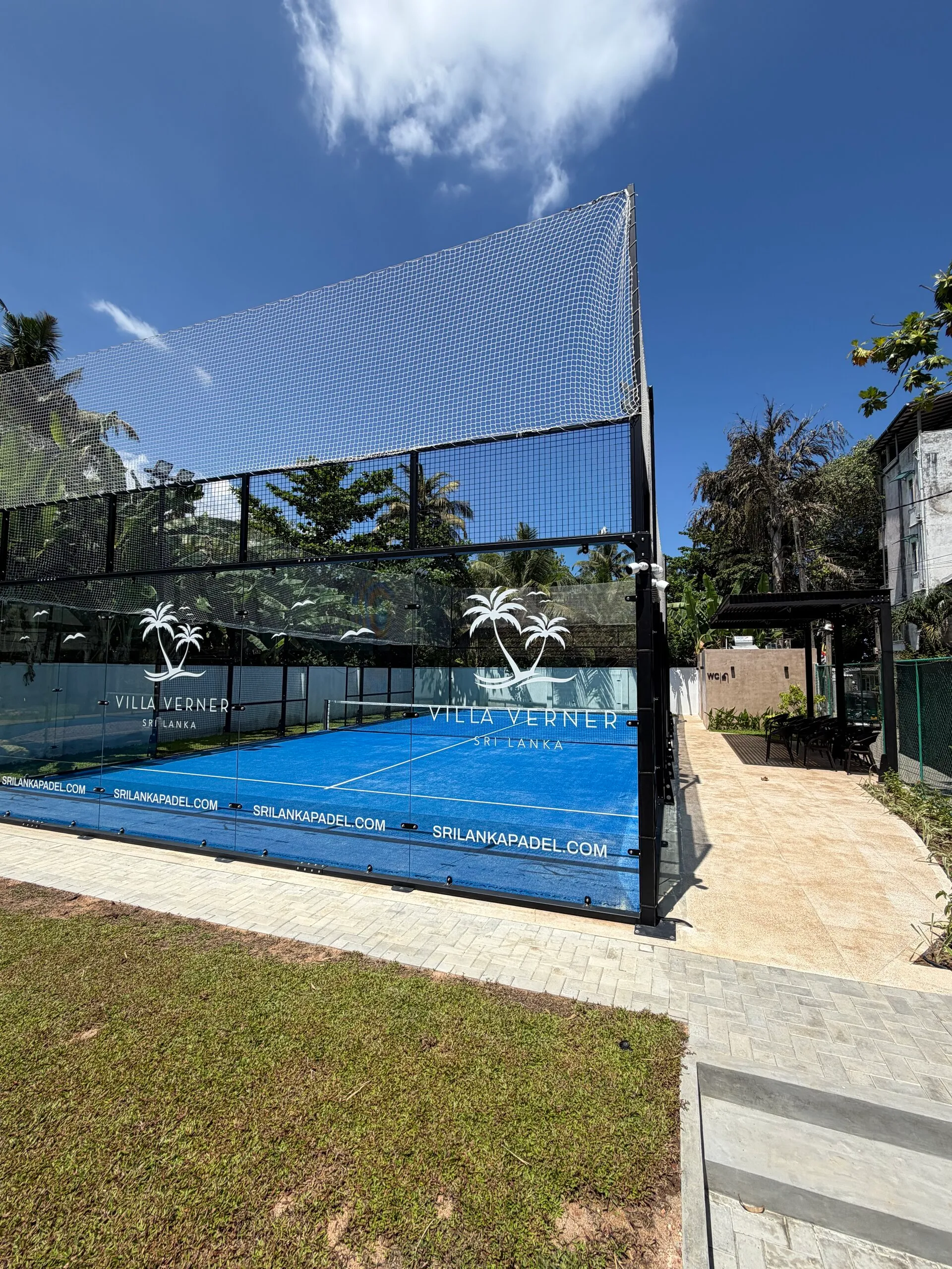 The Villa Verner panoramic padel court beneath the coconut palms